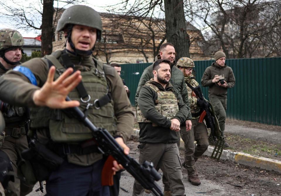 Zelensky walks in the town of Bucha (AFP via Getty Images)