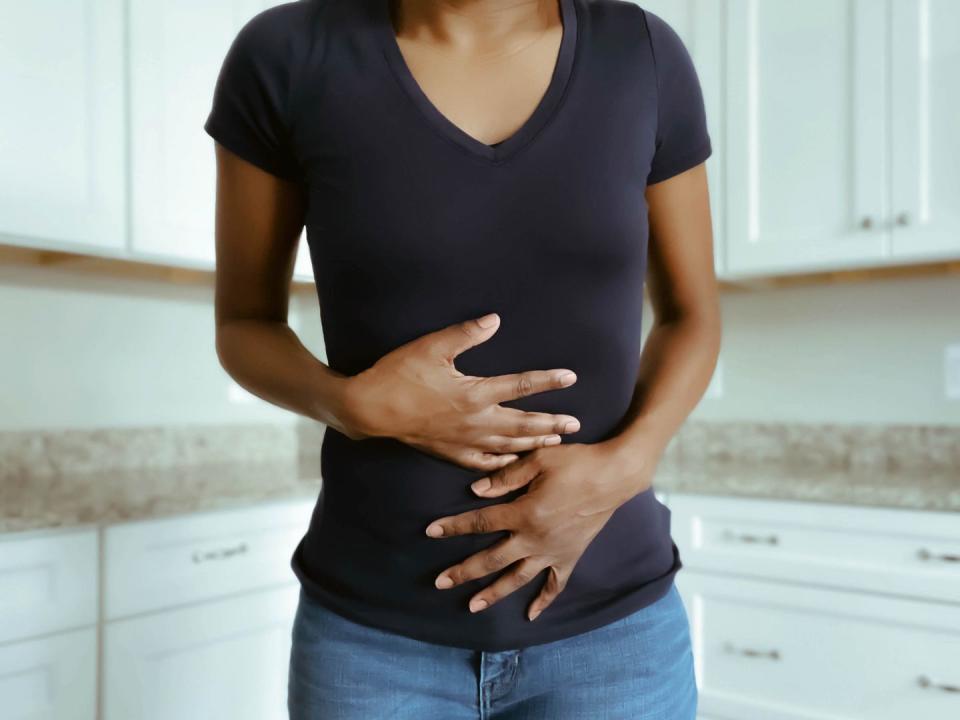 woman suffers stomach pains