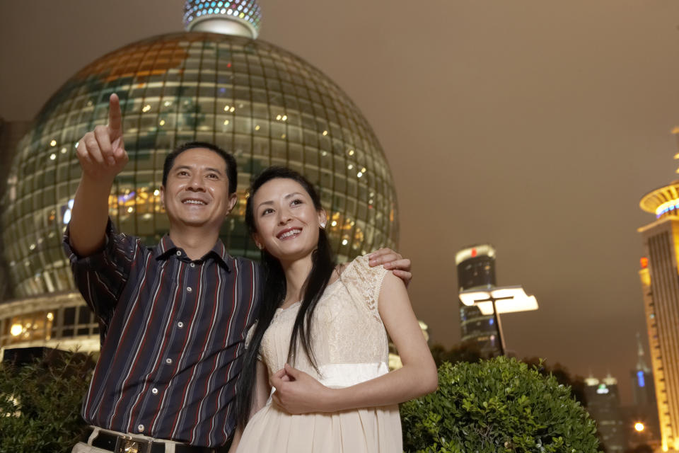 A man and a young woman enjoy travelling together.