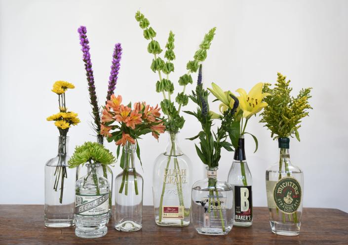 Nothing says Kentucky like decorating your Kentucky Derby party with a variety of garden cut florals arranged in empty Bourbon bottles.