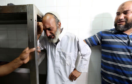 A relative of a Palestinian Islamic Jihad militant, who was killed in an Israeli tank shelling that targeted an observation post, reacts at a hospital in the southern Gaza Strip May 27, 2018. REUTERS/Ibraheem Abu Mustafa