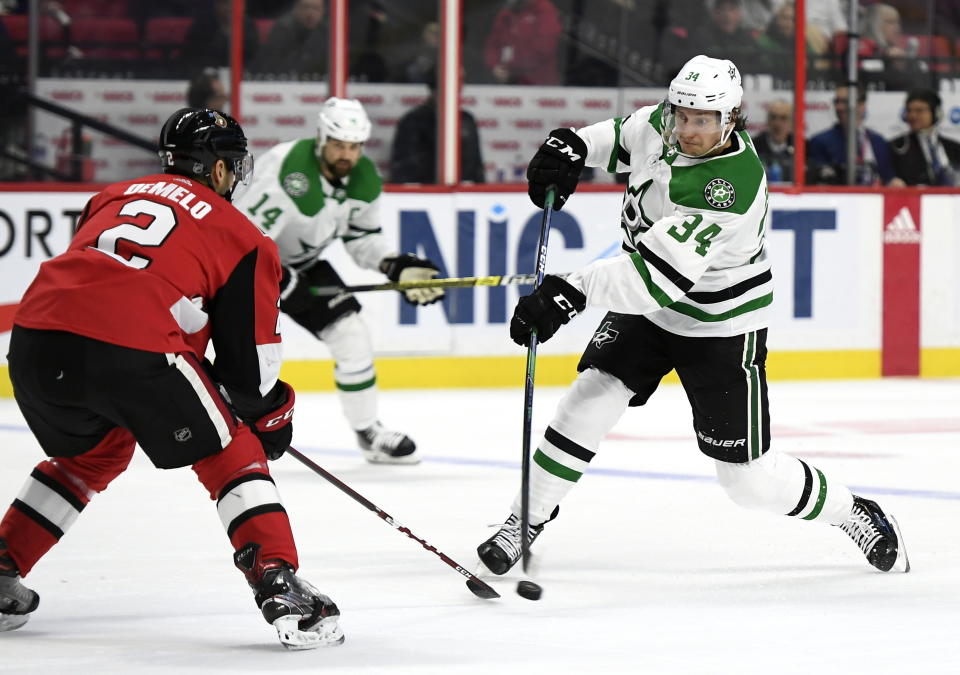 Dallas Stars right wing Denis Gurianov (34) shoots in front of Ottawa Senators defenseman Dylan DeMelo (2) during the second period of an NHL hockey game Sunday, Feb. 16, 2020, in Ottawa, Ontario. (Justin Tang/The Canadian Press via AP)