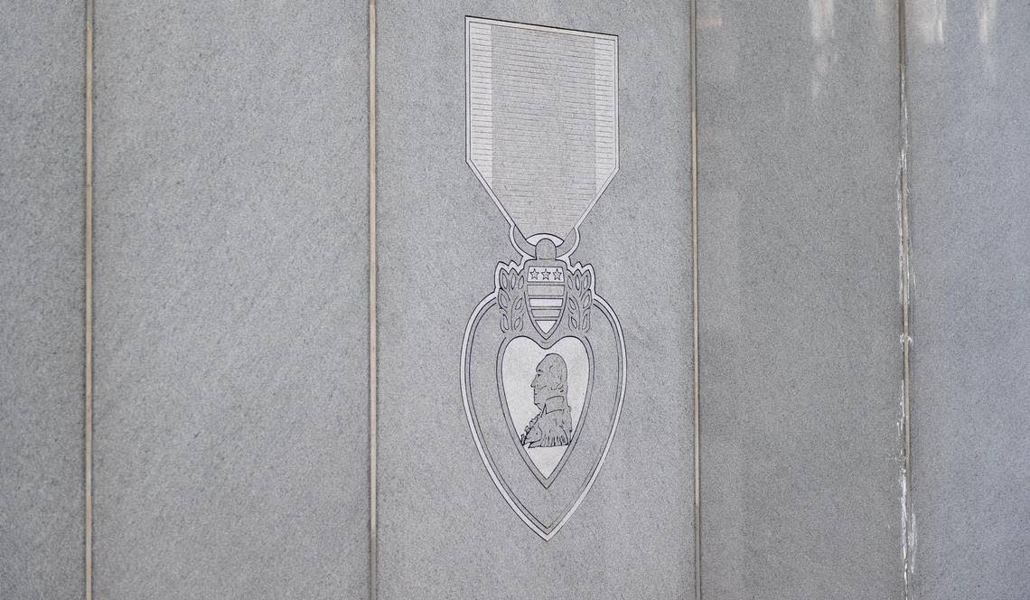 This memorial has an engraving of a Purple Heart Medal on it.