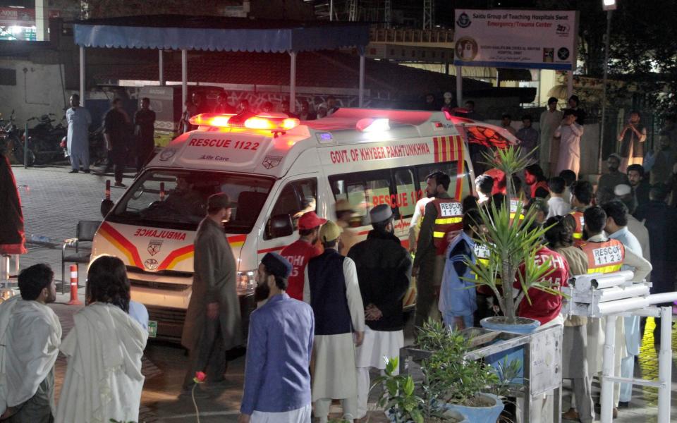 Rescue workers unload earthquake victims from an ambulance at a hospital in Saidu Sharif, a town in Pakistan's Swat Valley - AP