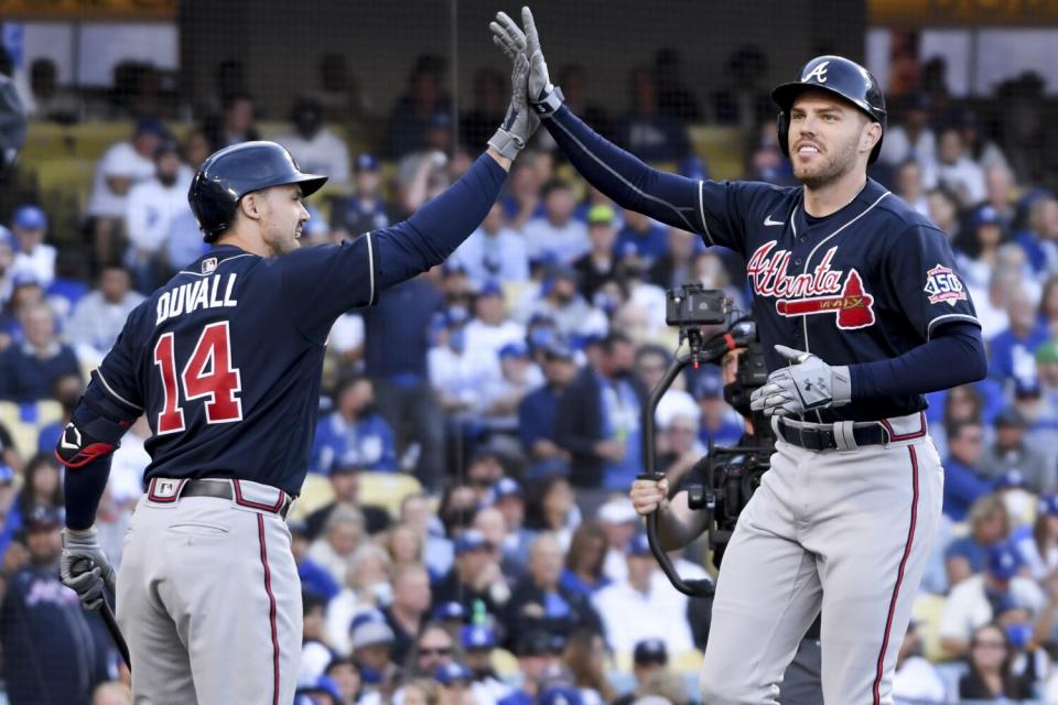 The Braves' Freddie Freeman celebrates with Adam Duvall after a two-run homer.