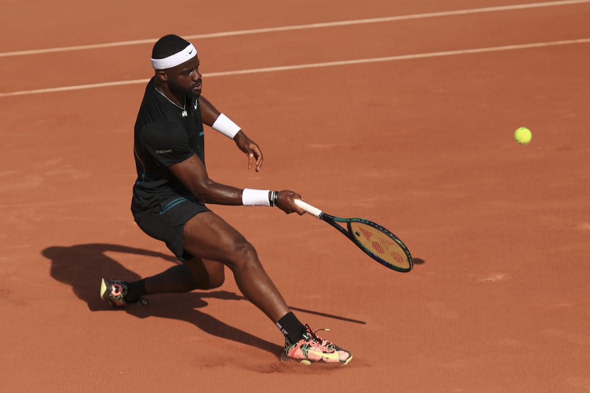 Frances Tiafoe of the U.S. plays a shot against Serbia’s Filip Krajinovic during their first-round match of the French Open tennis tournament at the Roland Garros stadium in Paris, May 29, 2023. The group that runs the French Open tennis tournament has hired an artificial intelligence company to monitor players’ social media accounts in a bid to try to protect athletes from cyberbullying. (AP Photo/Aurelien Morissard, File)