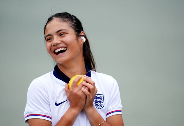 Emma Raducanu wears an England football shirt during a practice session at Wimbledon