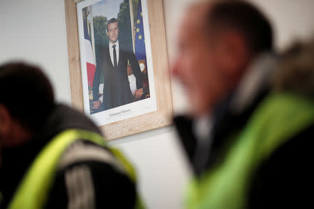 FILE PHOTO: The official portrait of French President Emmanuel Macron is seen during a meeting with yellow vests movement members at the city hall in Flagy, France, January 9, 2019. Picture taken January 9, 2019. REUTERS/Benoit Tessier/File Photo