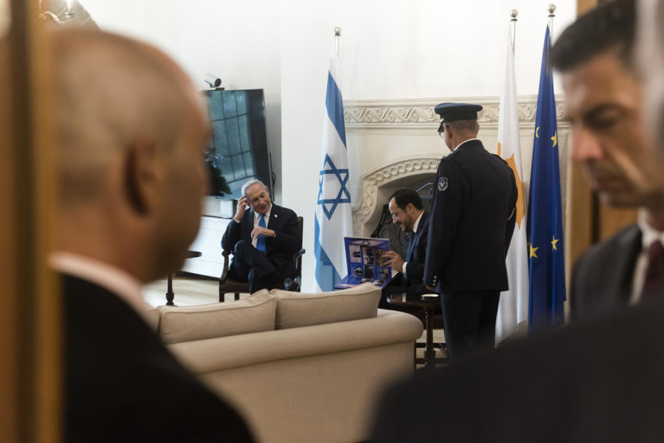 Cypriot President Nikos Christodoulides, right background, and Israeli Prime Minister Benjamin Netanyahu, left background are seen during their meeting at the presidential palace in the capital Nicosia, Cyprus, on Sunday, Sept. 3, 2023. An official statement said Christodoulides and Netanyahu will touch on expanding energy cooperation and bilateral ties, as well as Israel's relations with the European Union. The leaders' meeting comes a day ahead of a trilateral meeting that will include Greek Prime Minister Kyriakos Mitsotakis. (Iakovos Hatzistavrou, Pool via AP)