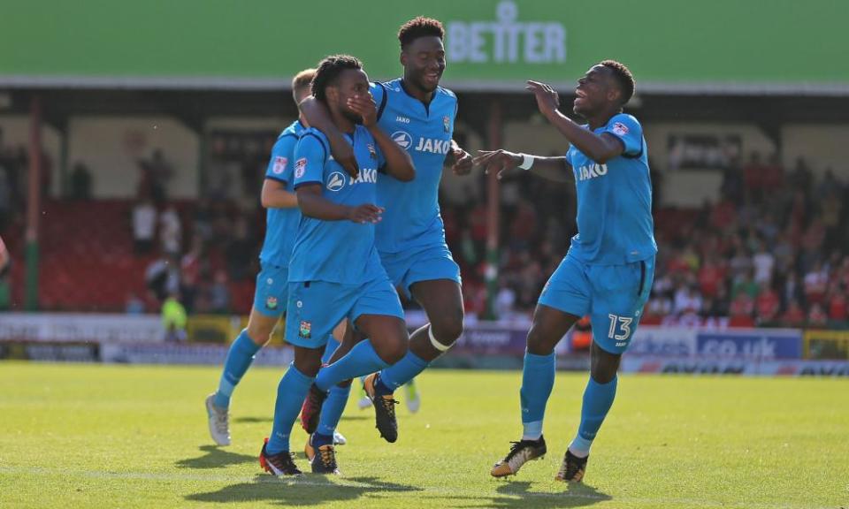 Barnet’s Shaq Coulthirst, left, celebrates his hat-trick in the 4-1 win over Swindon at the County Ground.