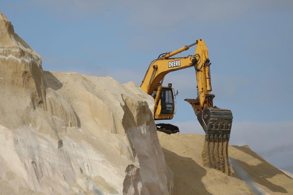 Work is ongoing at the iconic Granite State Minerals salt piles in Portsmouth Tuesday, Jan. 31, 2023, ahead of frigid weather expected this week.