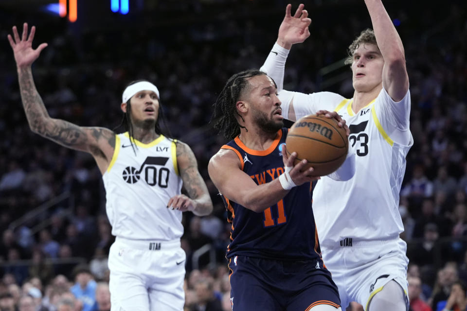 New York Knicks guard Jalen Brunson (11) looks to move the ball around Utah Jazz forward Lauri Markkanen (23) during the first half of an NBA basketball game, Tuesday, Jan. 30, 2024, at Madison Square Garden in New York. (AP Photo/Mary Altaffer)