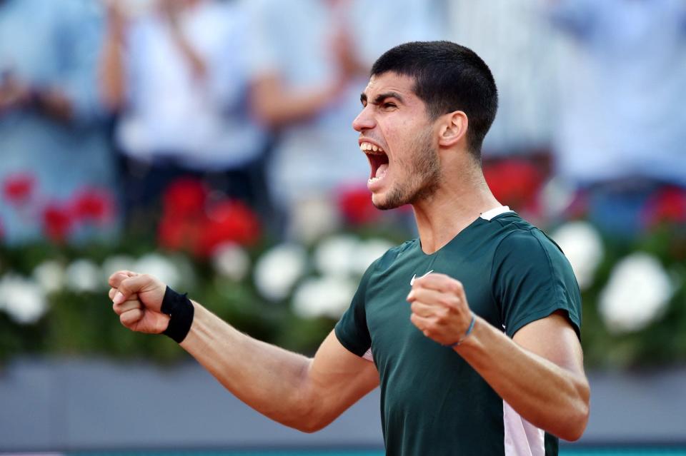 Carlos Alcaraz of Spain celebrates after winning match point in their Men's Singles semi-finals match against Novak Djokovic of Serbia during day ten of Mutua Madrid Open at La Caja Magica