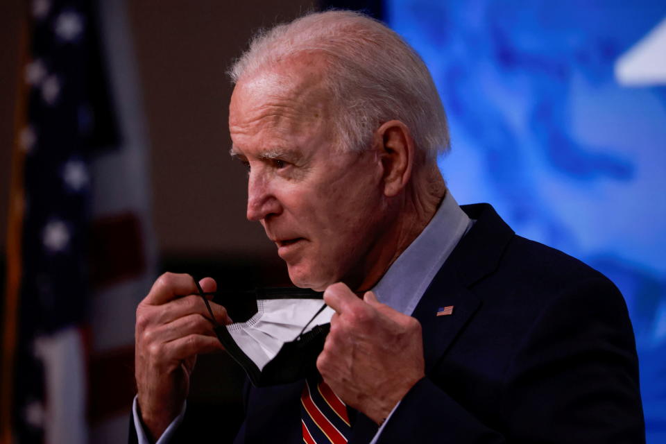 President Joe Biden removes his face mask to speak about the status of coronavirus disease (COVID-19) vaccinations and his administration's ongoing COVID-19 pandemic response in the Eisenhower Executive Office Building at the White House in Washington on April 21, 2021. (Tom Brenner/Reuters)