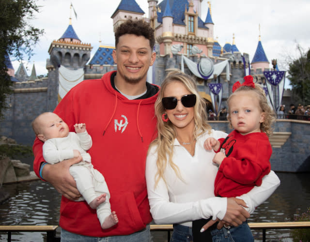 ANAHEIM, CALIFORNIA – FEBRUARY 13:Patrick Mahomes of the Kansas City Chiefs and Brittney Mahomes pose with their children, Sterling, 1, and Bronze, 11 weeks old, in front of Sleeping Beauty Castle at Disneyland Park on February 13, 2023, in Anaheim, California. <em>Photo by Christian Thompson/Disneyland Resort via Getty Images.</em>