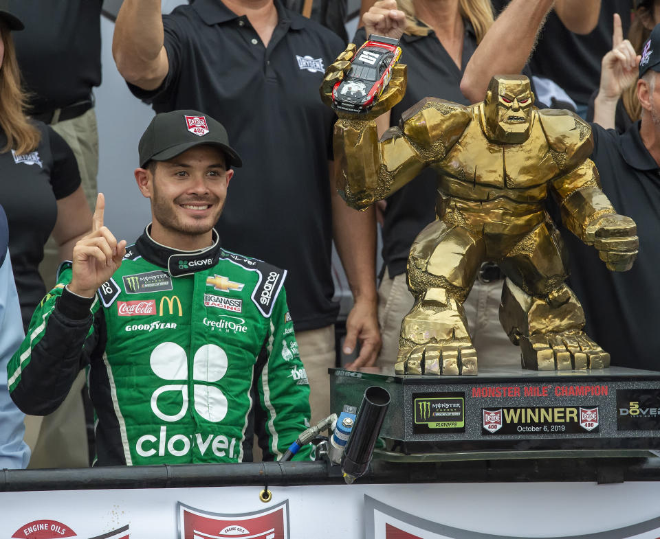 Kyle Larson stands next to the trophy after winning the NASCAR Cup Series auto race Sunday, Oct. 6, 2019, at Dover International Speedway in Dover, Del. (AP Photo/Jason Minto)