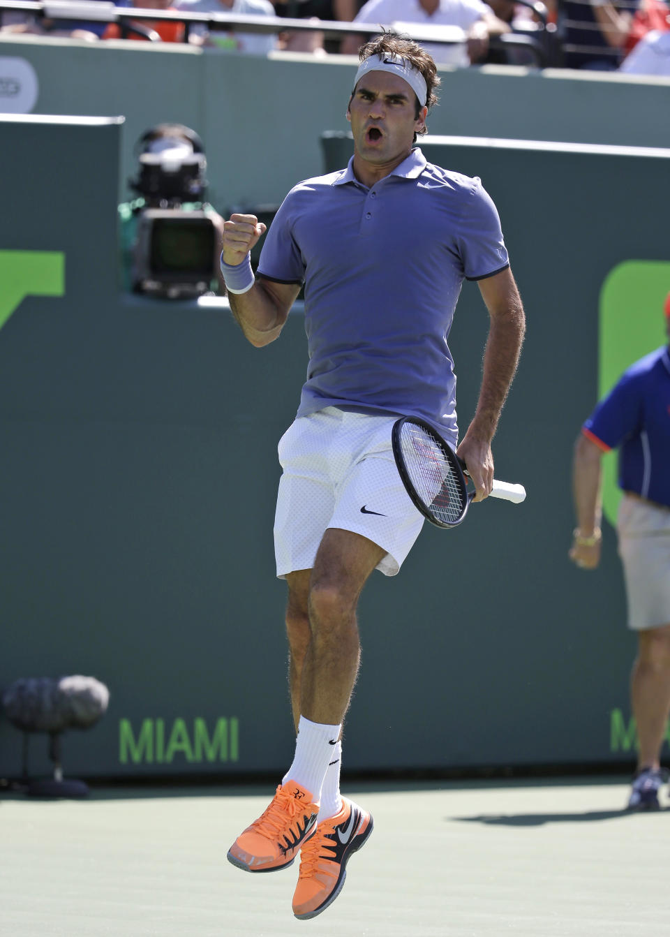 Roger Federer, of Switzerland, leaps into the air after defeating Ivo Karlovic, of Croatia, 6-4, 7-6 (7-4) at the Sony Open tennis tournament, Friday, March 21, 2014, in Key Biscayne, Fla. (AP Photo/Lynne Sladky)
