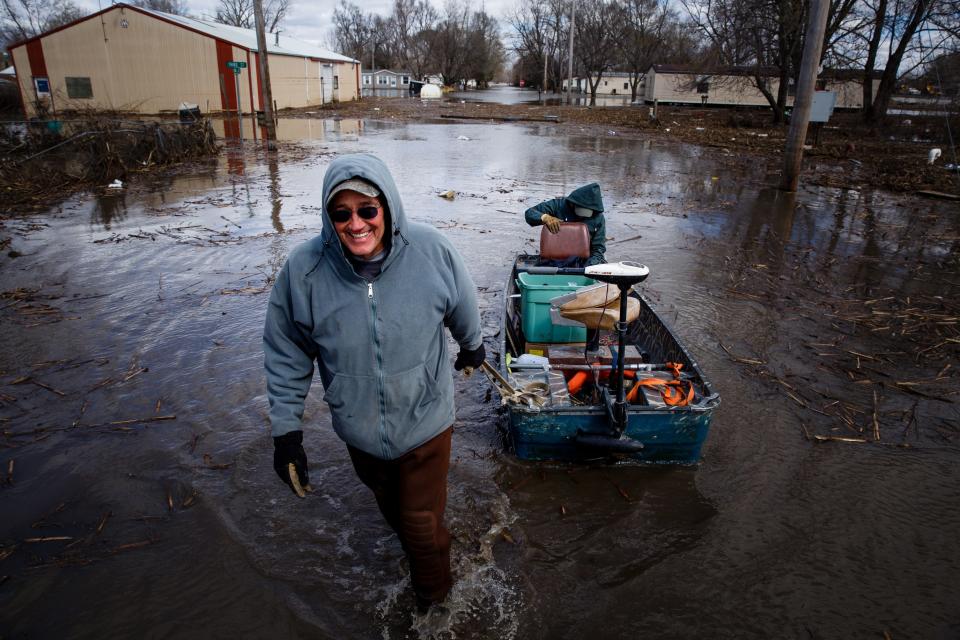 After cleaning and replacing the breakers and fuses in the third of his three pumps Mayor Andy Young pulls electrician Ben Lundstrom back to Main street in his fishing boat on Friday, April 12, 2019, in Pacific Junction. The levees meant to protect Pacific Junction created a bowl, holding the water in town. The electrical boxes for the towns pumps were all underwater as well so until those were exposed, Young couldn't get to them to start the pumps back up.