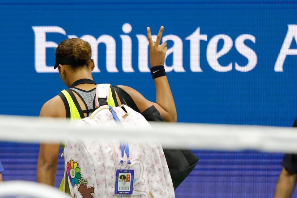 Naomi Osaka gestures as she leaves the court after losing to Leylah Fernandez at the U.S. Open.