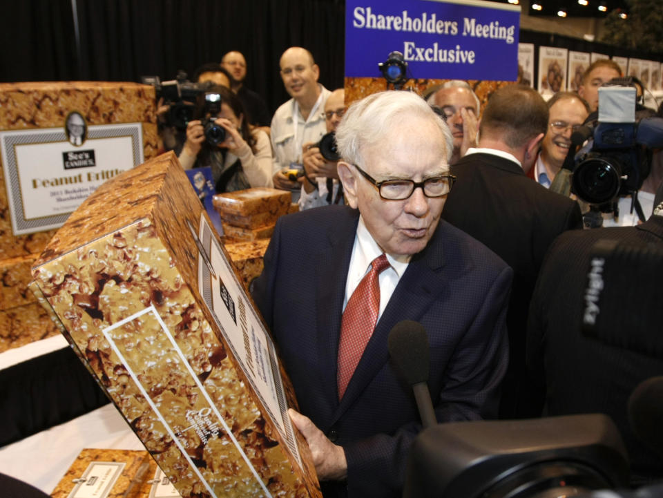Berkshire Hathaway Chairman Warren Buffett holds a 25 pound box of See&#39;s peanut brittle, one of his favorites, before his company&#39;s annual meeting in Omaha, Nebraska April 30, 2011. See&#39;s Candies is a BH company.  REUTERS/Rick Wilking  (UNITED STATES - Tags: BUSINESS FOOD)