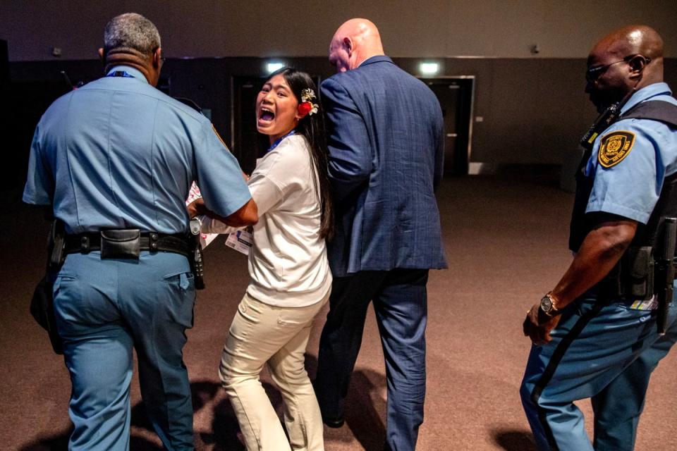 Security officers escort indigenous climate activist from India, Licypriya Kangujam,12, as she protests at the 2023 United Nations Climate Change Conference (COP28 (EPA)