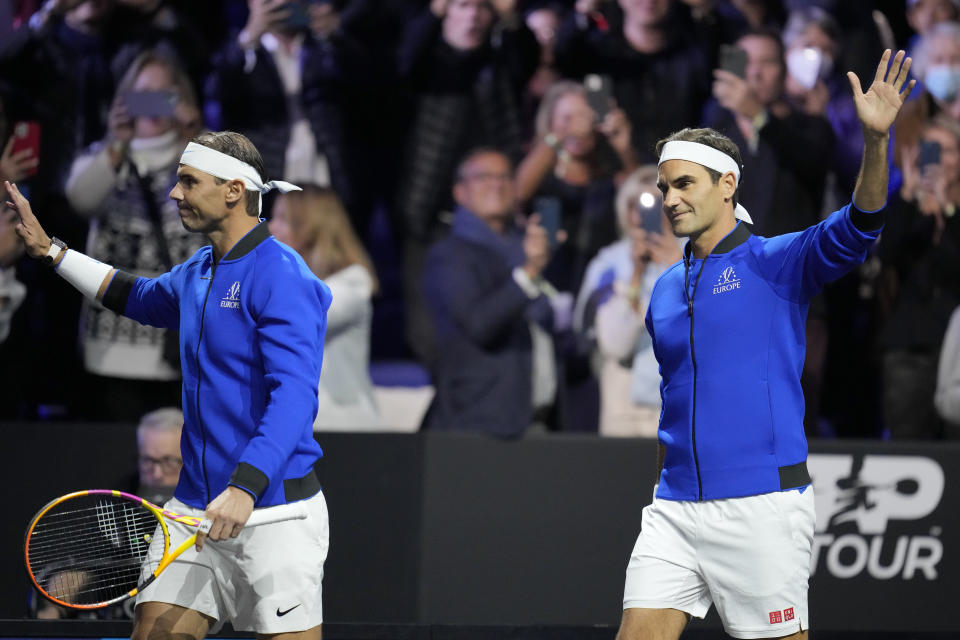 Team Europe's Roger Federer, right, and Rafael Nadal wave as they arrive for their Laver Cup doubles match against Team World's Jack Sock and Frances Tiafoe at the O2 arena in London, Friday, Sept. 23, 2022. (AP Photo/Kin Cheung)