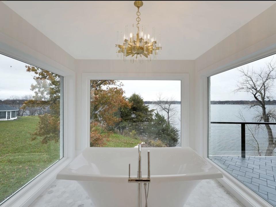 The bathtub in the master bathroom comes with windows that overlook the surrounding lake.