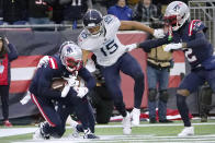 New England Patriots cornerback J.C. Jackson, left, intercepts a pass in the end zone as Tennessee Titans wide receiver Nick Westbrook-Ikhine (15) looks on during the second half of an NFL football game, Sunday, Nov. 28, 2021, in Foxborough, Mass. (AP Photo/Mary Schwalm)