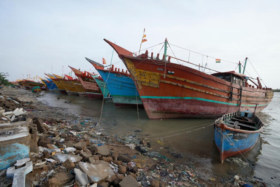 Boats stand anchored at Jakhau Port  in Kutch district, India (AP)