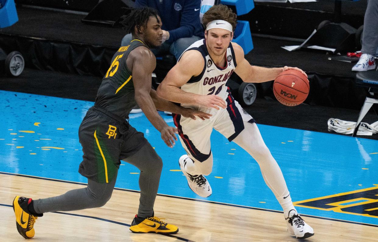 Gonzaga Bulldogs forward Corey Kispert (24) dribbles the basketball against Baylor Bears guard Davion Mitchell (45) in the second half during the national championship game in the Final Four of the 2021 NCAA Tournament at Lucas Oil Stadium.