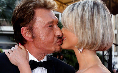 Johnny Hallyday and his wife Laeticia kiss during red carpet arrivals for the screening of the film "Vengeance" by director Johnnie To at the 62nd Cannes Film Festival May 17, 2009 - Credit:  Jean-Paul Pelissier/ REUTERS