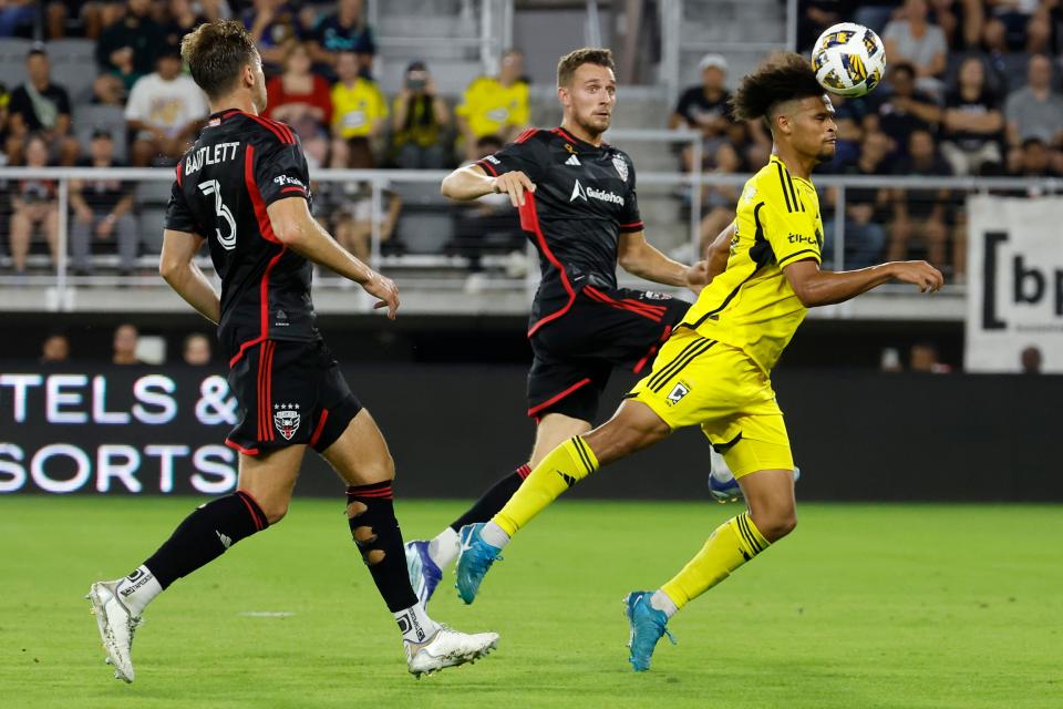 Sep 28, 2024; Washington, District of Columbia, USA; Columbus Crew forward Jacen Russell-Rowe (19) scores a goal on a header as D.C. United defender Christopher McVey (97) defends in the second half at Audi Field. Mandatory Credit: Geoff Burke-Imagn Images