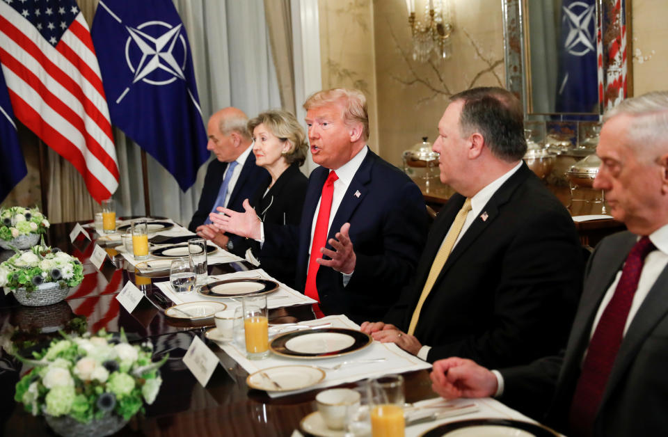 Donald Trump speaks to Jens Stoltenberg during a tense breakfast meeting in Brussels (Reuters)