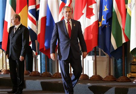 U.S. President George W. Bush (R) walks past Russian President Vladimir Putin as G8 leaders and outreach leaders gather for a group photo at the G8 summit in St. Petersburg, Russia, in this July 17, 2006 file photo. REUTERS/Jason Reed/Files