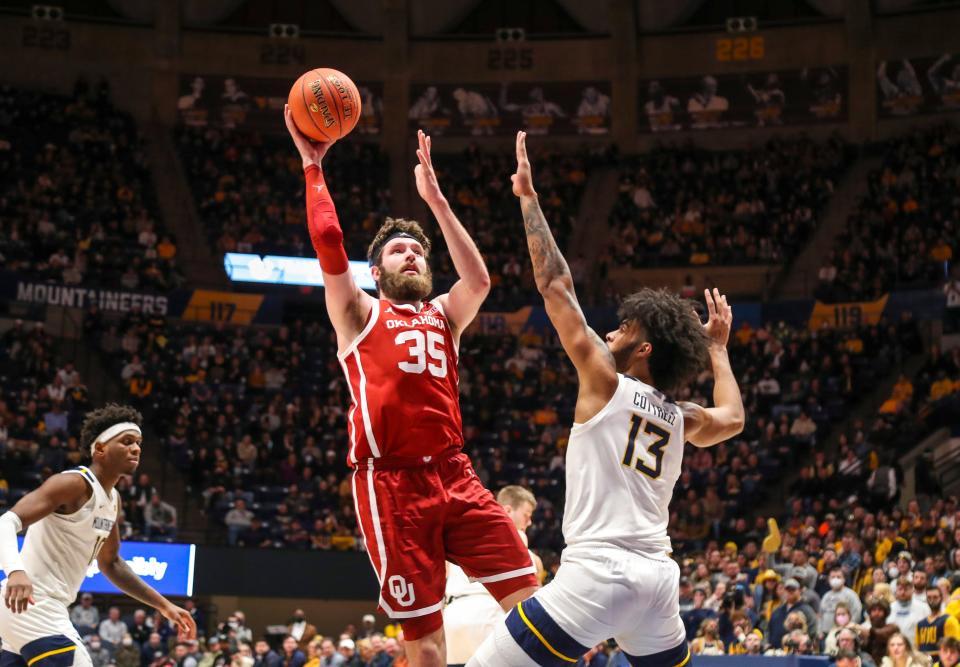 Oklahoma's Tanner Groves (35) shoots over West Virginia's  Isaiah Cottrell during Wednesday night's Big 12 basketball game at WVU Coliseum.