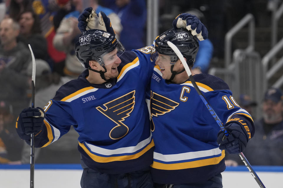St. Louis Blues' Brayden Schenn, right, is congratulated by teammate Pavel Buchnevich after scoring the game-winning goal during overtime of an NHL hockey game against the Los Angeles Kings Sunday, Jan. 28, 2024, in St. Louis. (AP Photo/Jeff Roberson)