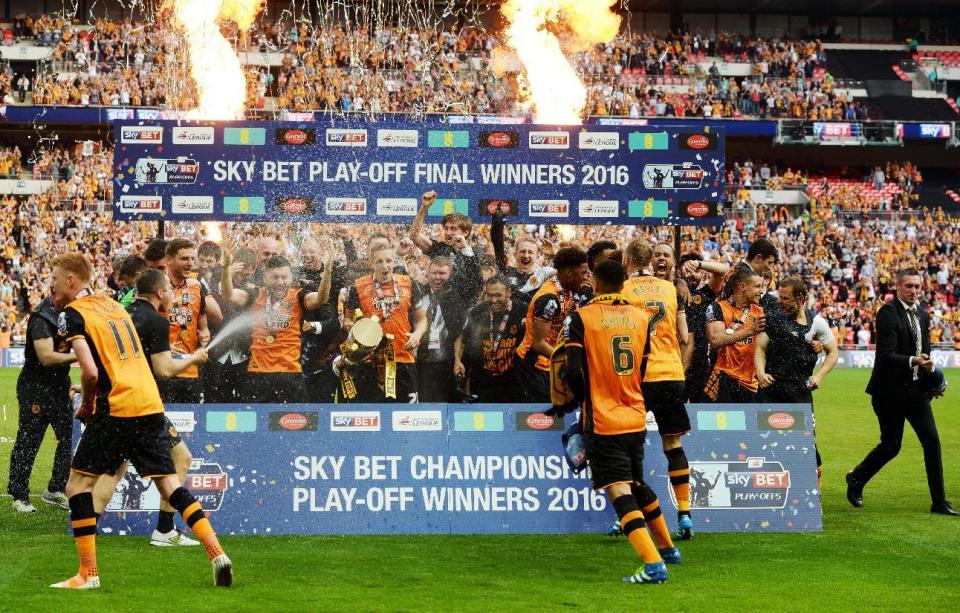 Britain Soccer Football - Hull City v Sheffield Wednesday - Sky Bet Football League Championship Play-Off Final - Wembley Stadium - 28/5/16 Hull City players celebrate with the trophy after winning promotion back to the Premier League Action Images via Reuters / Tony O'Brien Livepic EDITORIAL USE ONLY. No use with unauthorized audio, video, data, fixture lists, club/league logos or "live" services. Online in-match use limited to 45 images, no video emulation. No use in betting, games or single club/league/player publications. Please contact your account representative for further details.