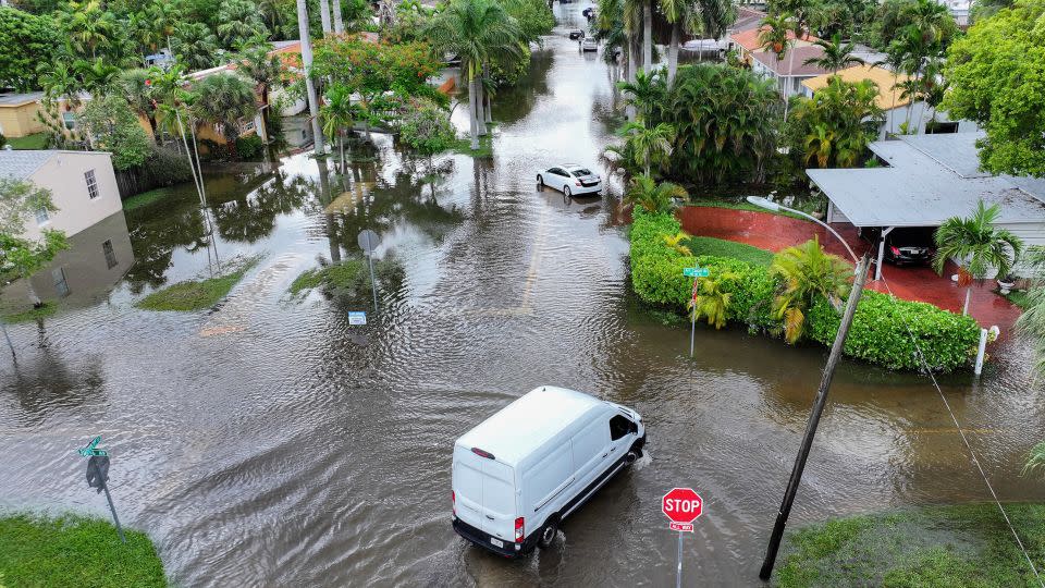 A vehicle is driven through a flooded street in Hallandale Beach, Florida, on Thursday. - Joe Raedle/Getty Images