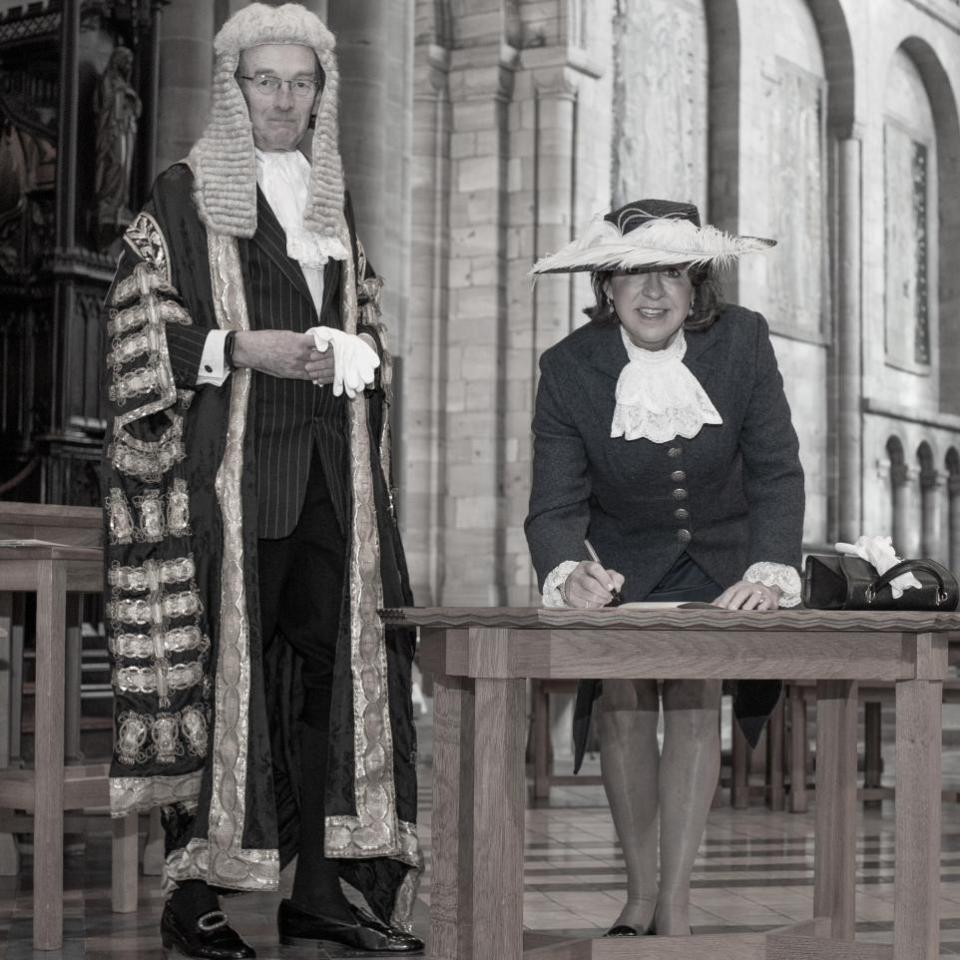 Hereford Times: Pat Churchward, pictured with High Court Judge Sir Andrew McFarlane, signs her declaration