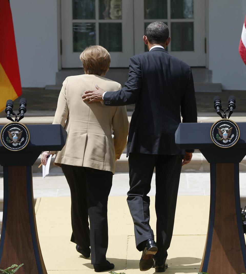 President Barack Obama and German Chancellor Angela Merkel leave their joint news conference in the Rose Garden of the White House in Washington, Friday, May 2, 2014. Obama and Merkel are putting on a display of trans-Atlantic unity against an assertive Russia, even as sanctions imposed by Western allies seem to be doing little to change Russian President Vladimir Putin's reasoning on Ukraine. (AP Photo/Charles Dharapak)