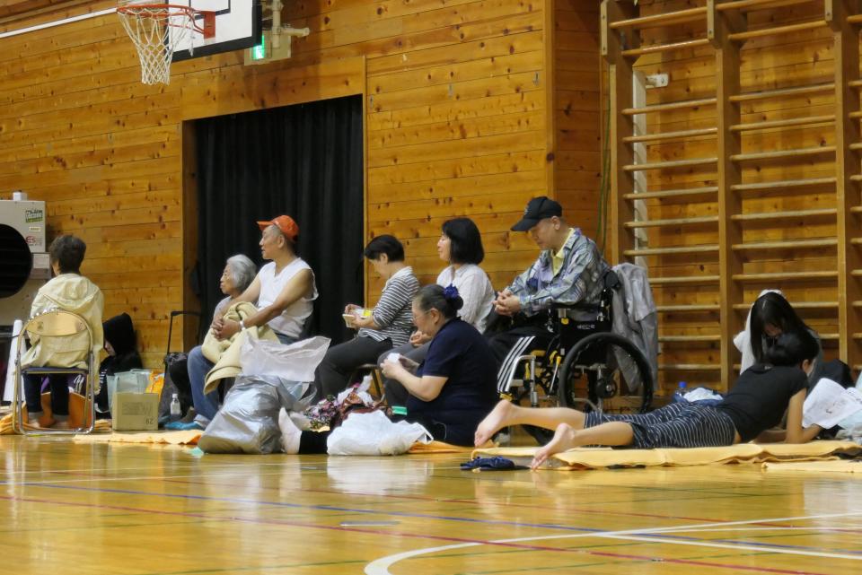 Evacuated residents sit inside a shelter to wait out the storm in Tokyo on October 12, 2019, ahead of Typhoon Hagibis' expected landfall in central or eastern Japan later in the evening. - More than 3.2 million people have been placed under non-compulsory evacuation orders as authorities warn of imminent flood and landslide danger after hours of torrential rains. (Photo by Karyn NISHIMURA / AFP) (Photo by KARYN NISHIMURA/AFP via Getty Images)