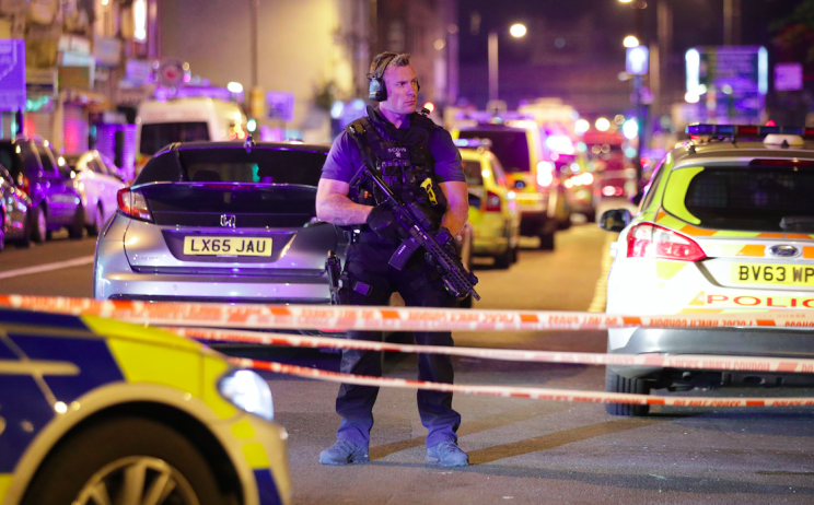 Armed police stand guard after pedestrians were ploughed into (PA)