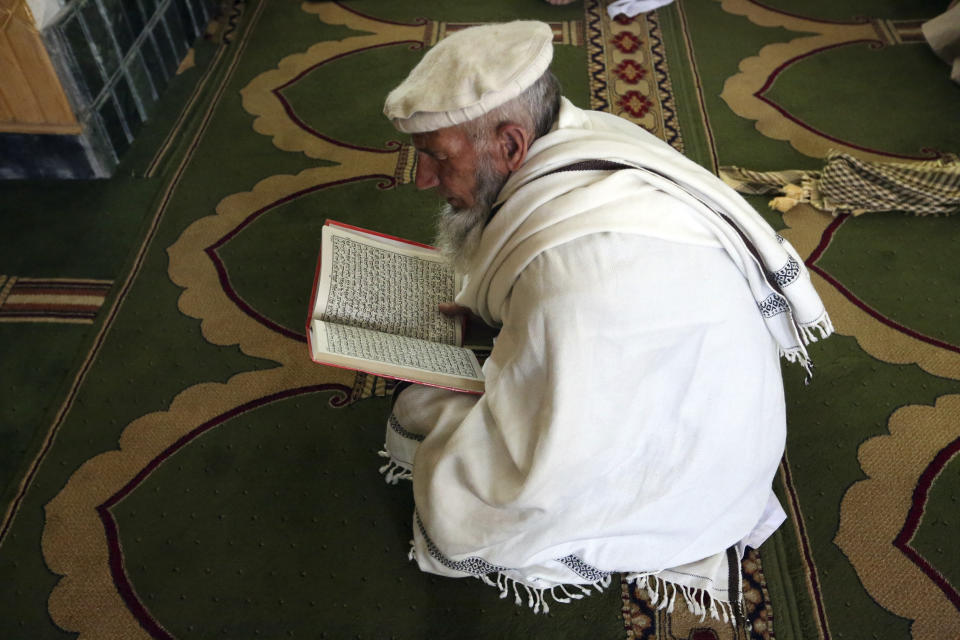 A Muslim reads passages from the Quran during the first day of the holy fasting month of Ramadan at a mosque in Kabul, Afghanistan, Friday, April 24, 2020. (AP Photo/Rahmat Gul)