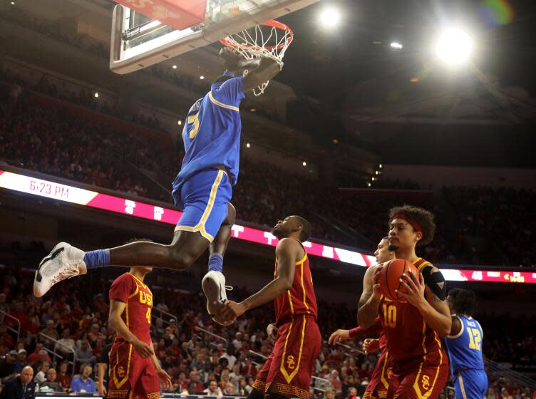 LOS ANGELES, CA - JANUARY 27, 2024 - - UCLA Bruins Adem Bona slams two points over USC Trojans during the second period at the Galen Center in Los Angeles on January 27, 2024. (Genaro Molina/Los Angeles Times)