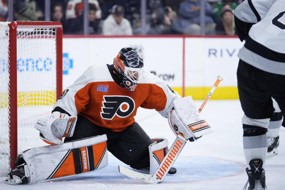 Philadelphia Flyers' Cal Petersen, left, blocks a shot by Los Angeles Kings' Drew Doughty during the third period of an NHL hockey game, Saturday, Nov. 4, 2023, in Philadelphia. (AP Photo/Matt Slocum)