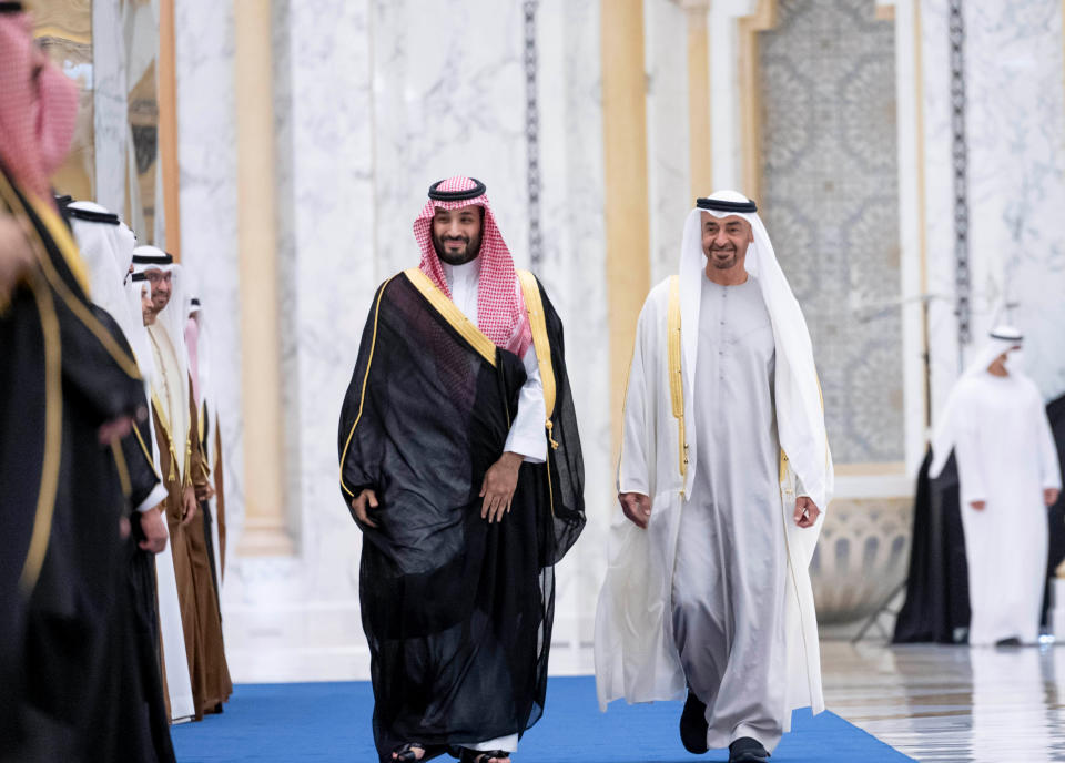 In this photo released by the state-run WAM news agency, Saudi Crown Prince Mohammed bin Salman, left, and Abu Dhabi's powerful crown prince, Sheikh Mohammed bin Zayed Al Nahyan, walk into a reception in Abu Dhabi, United Arab Emirates, Tuesday, Dec. 7, 2021. After years of looking abroad, mainly to the West, for answers to regional problems, Middle East countries now appear to instead be turning inward, talking to each other about resolving long-running tensions and issues. (Hamad Al Kaabi/Emirati Ministry of Presidential Affairs via AP)