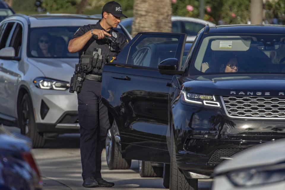 PBSO deputies search vehicles outside the Gardens Mall after a shooting there on February 14, 2024, in Palm Beach Gardens, Florida.