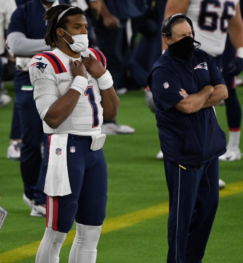 Patriots quarterback Cam Newton (1) on the sidelines with head coach Bill Belichick after getting replaced in the fourth quarter against the Los Angeles Rams at SoFi Stadium on Dec. 10, 2020.