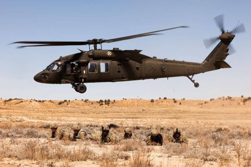 Cavalry scouts with the 2nd Stryker Brigade Combat Team wait as the Black Hawk helicopter that dropped them off for Operation Steel Eagle takes off on March 31, 2022, in Fort Carson, Colorado.