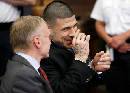 FILE PHOTO - Former New England Patriots football player Aaron Hernandez (R) smiles while speaking with his defense attorney Charlie Rankin before a hearing in Suffolk Superior Court before a hearing in Boston, Massachusetts, U.S. on June 24, 2014. REUTERS/Steven Senne/Pool/File Photo